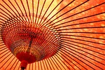 Close-up of a traditional orange Japanese bamboo umbrella (wagasa), symbolizing care and shelter for homes managed by Property Management Kyoto
