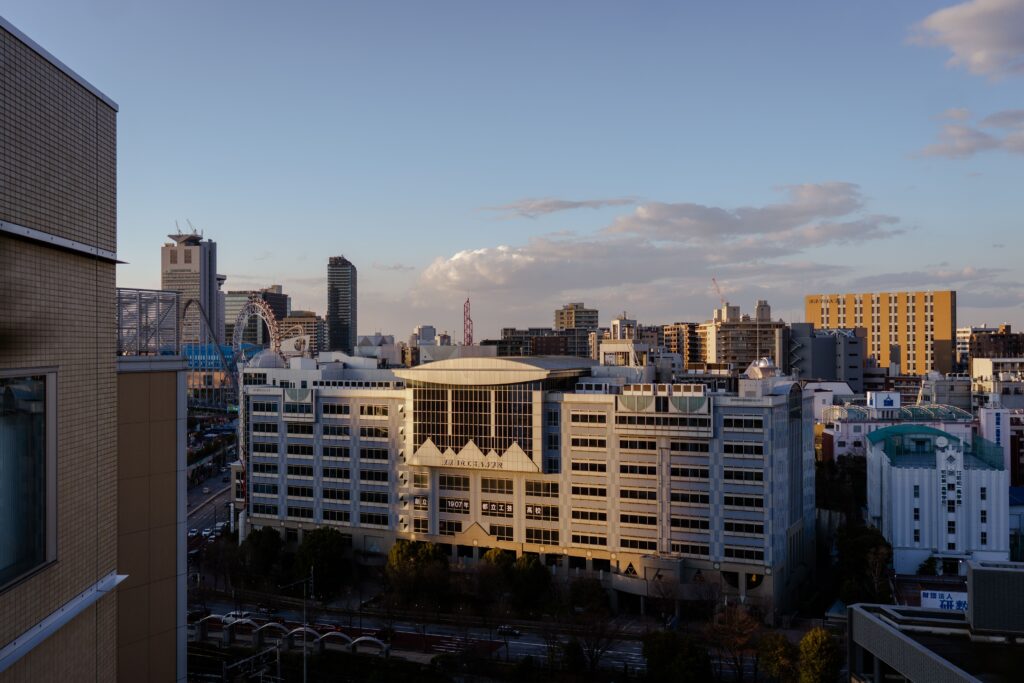Japan's Aging Apartment Problem Aerial view of a modern city skyline with contemporary architecture at dusk.